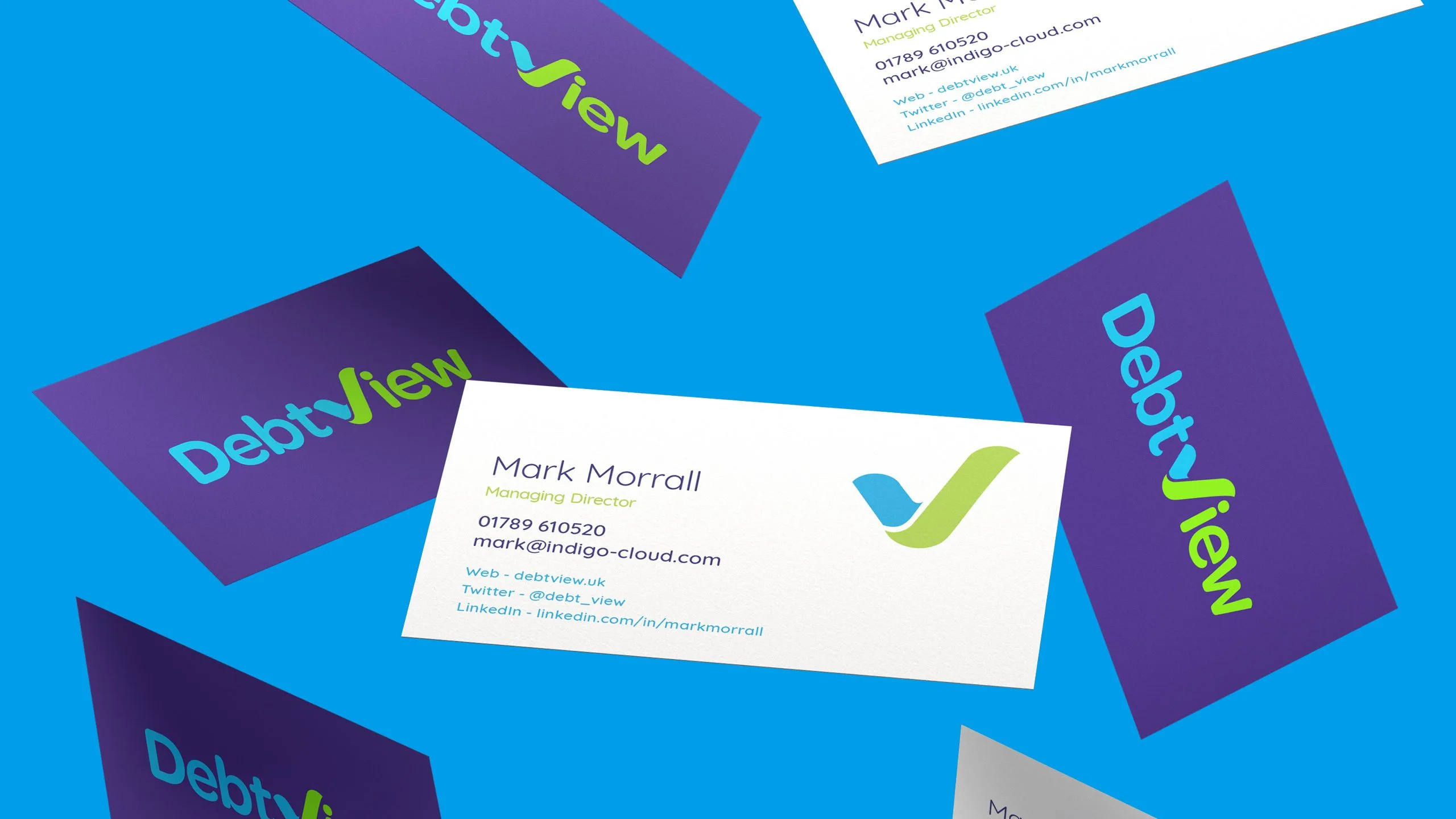 DebtView business cards with the new V and tick logo, scattered on a bright blue background
