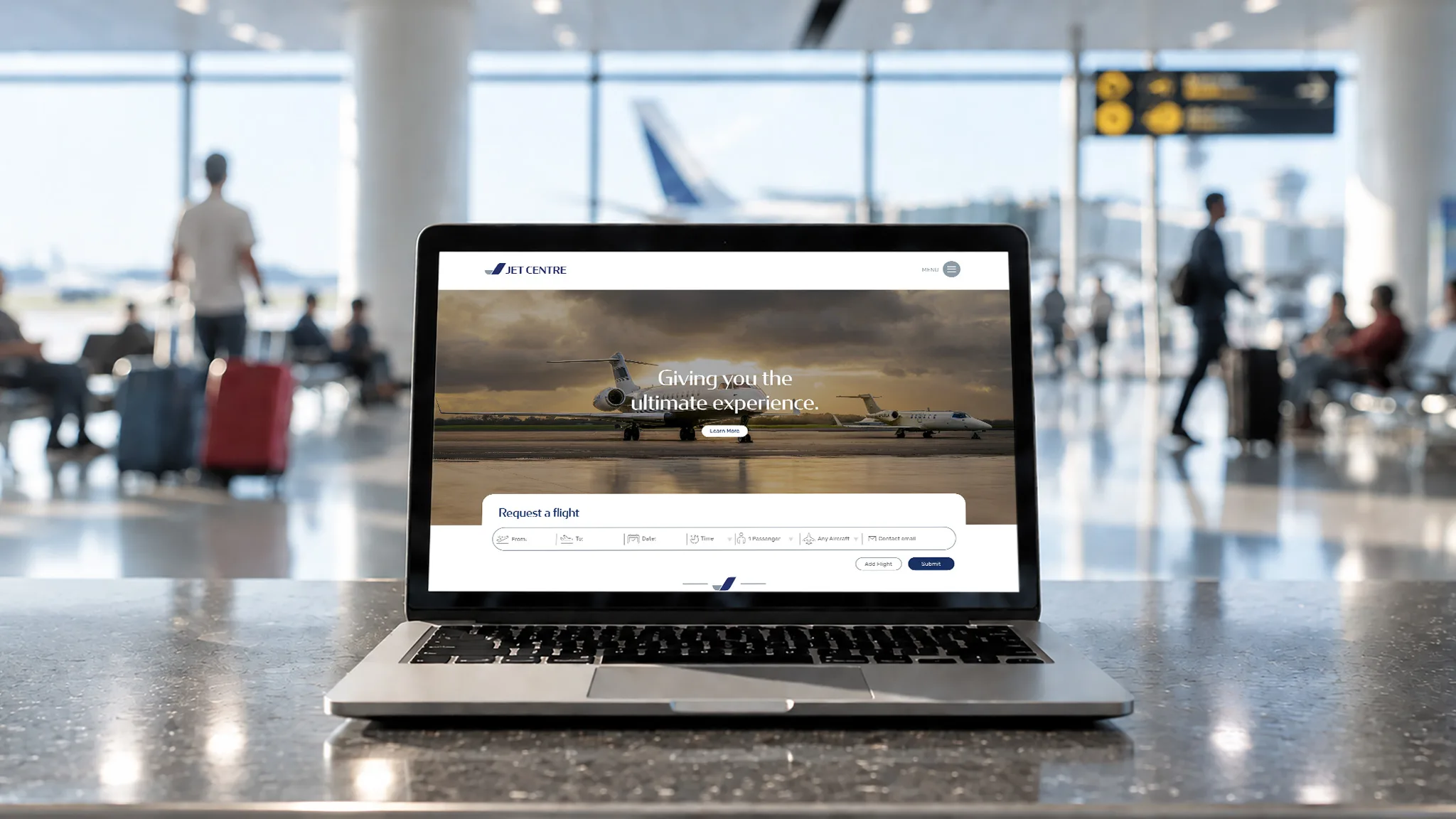 Jet Centre private jet charter website designed by CJ Creates, shown on a laptop in an airport lounge