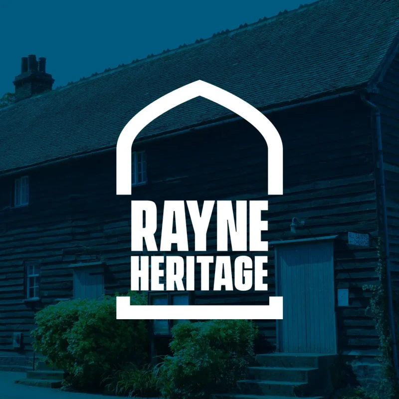 White Rayne Heritage logo over a blue-toned photo of a historic weatherboarded building in Rayne, Essex